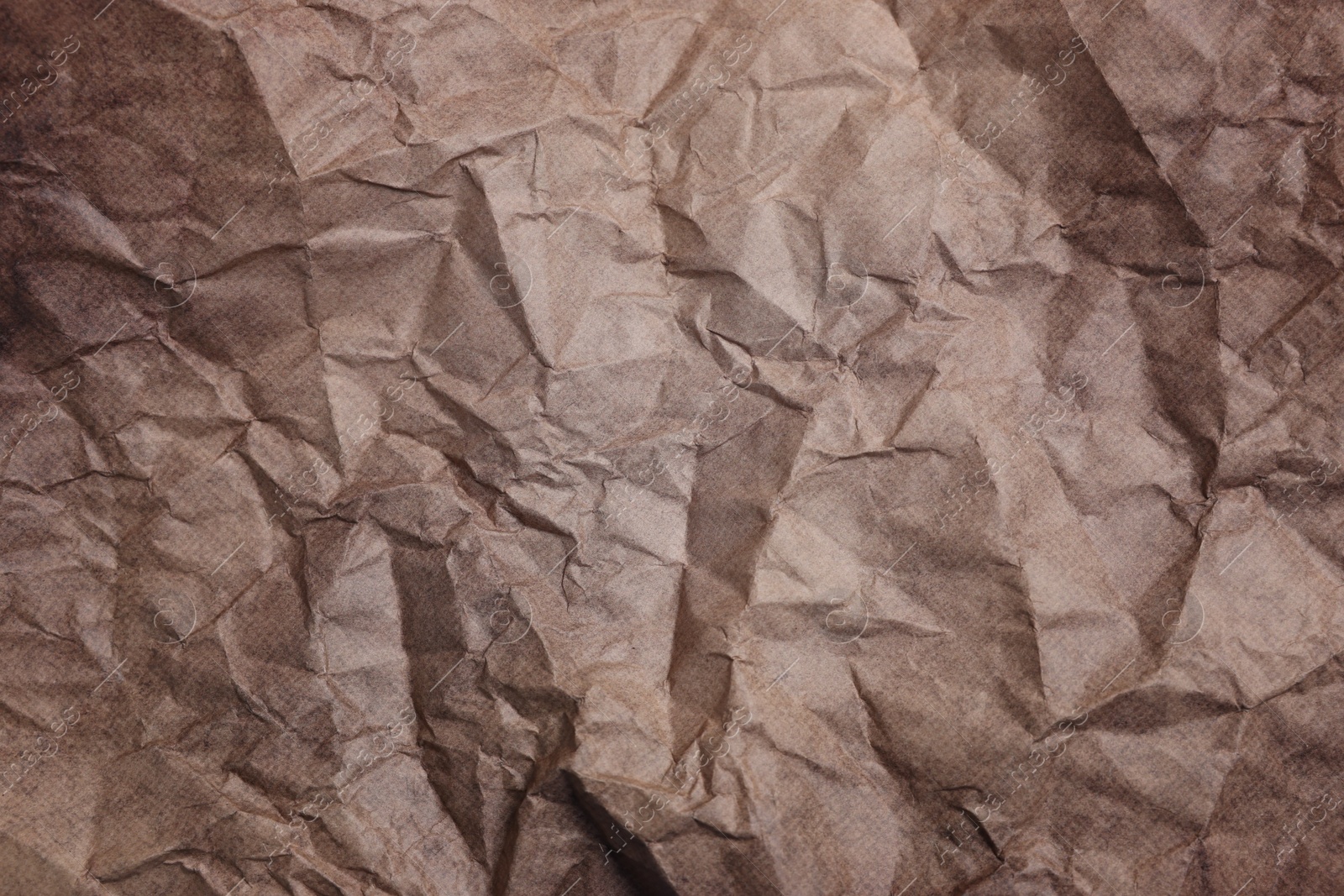 Photo of Texture of crumpled parchment paper as background, top view