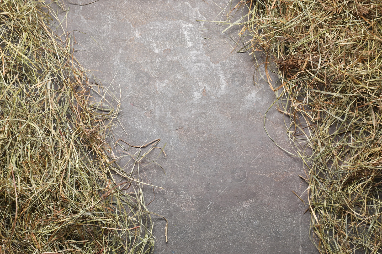 Photo of Frame made of dried hay on grey table, top view. Space for text