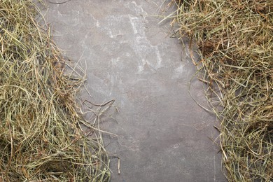 Frame made of dried hay on grey table, top view. Space for text