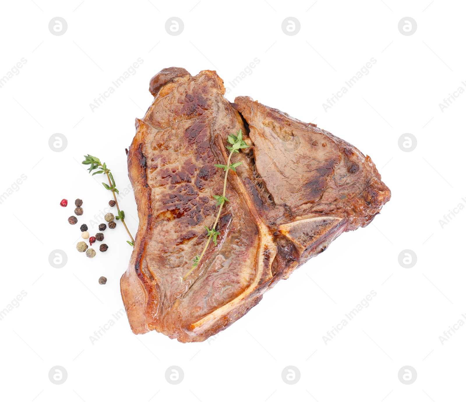 Photo of Delicious fried beef meat, thyme and peppercorns isolated on white, top view
