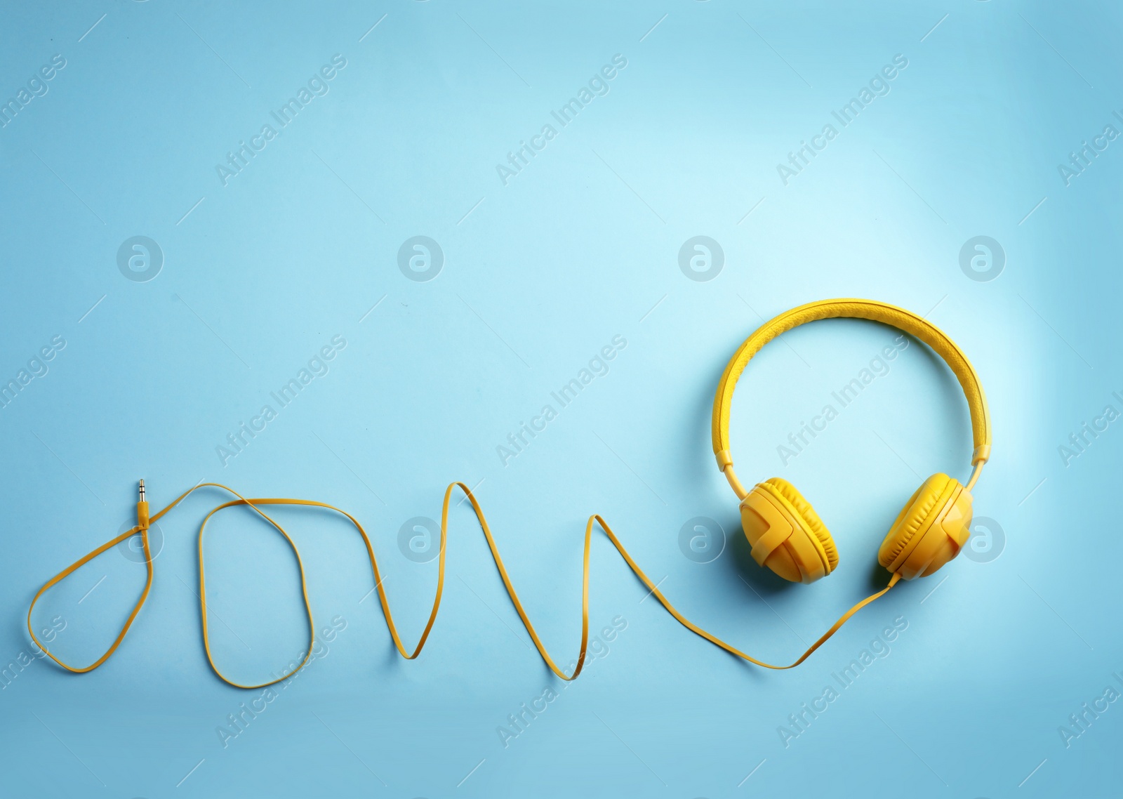 Photo of Stylish headphones on color background, top view. Space for text