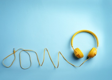 Photo of Stylish headphones on color background, top view. Space for text