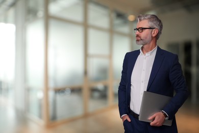 Image of Successful lawyer with laptop on blurred background, space for text