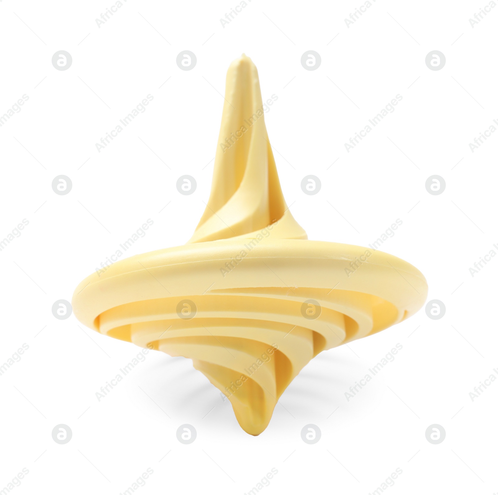 Photo of One pale yellow spinning top on white background