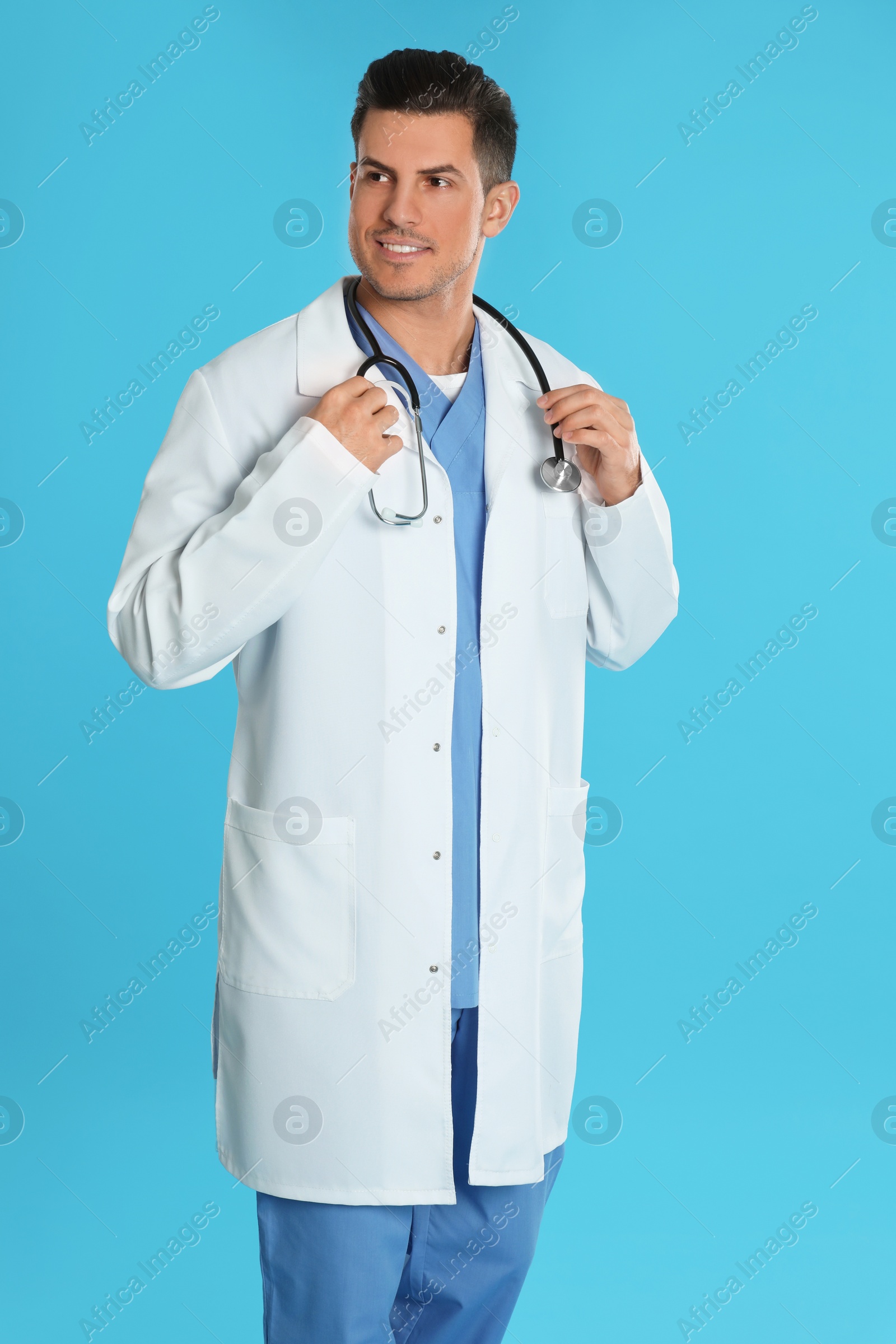 Photo of Portrait of doctor with stethoscope on blue background