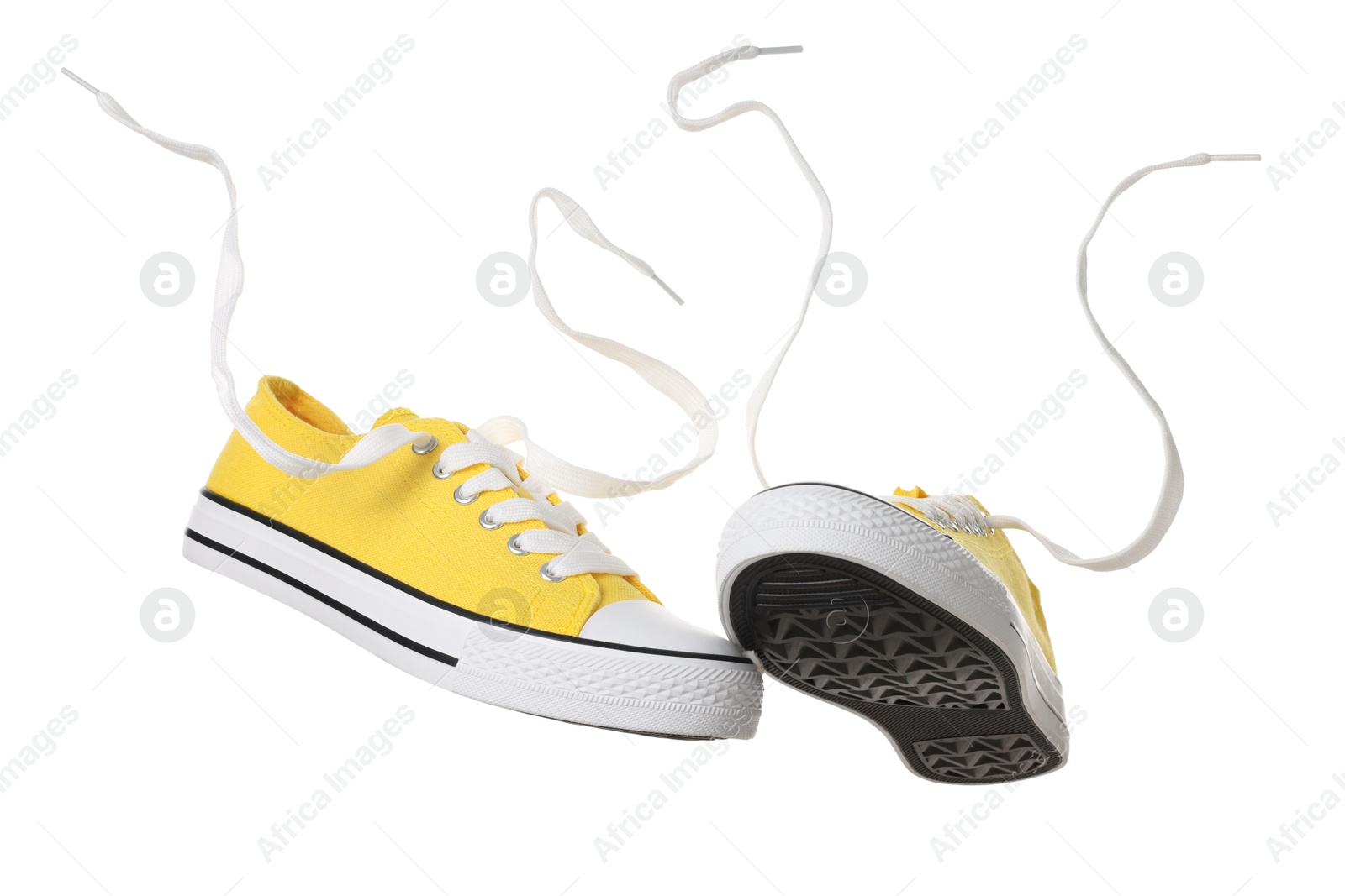 Photo of Pair of yellow classic old school sneakers on white background