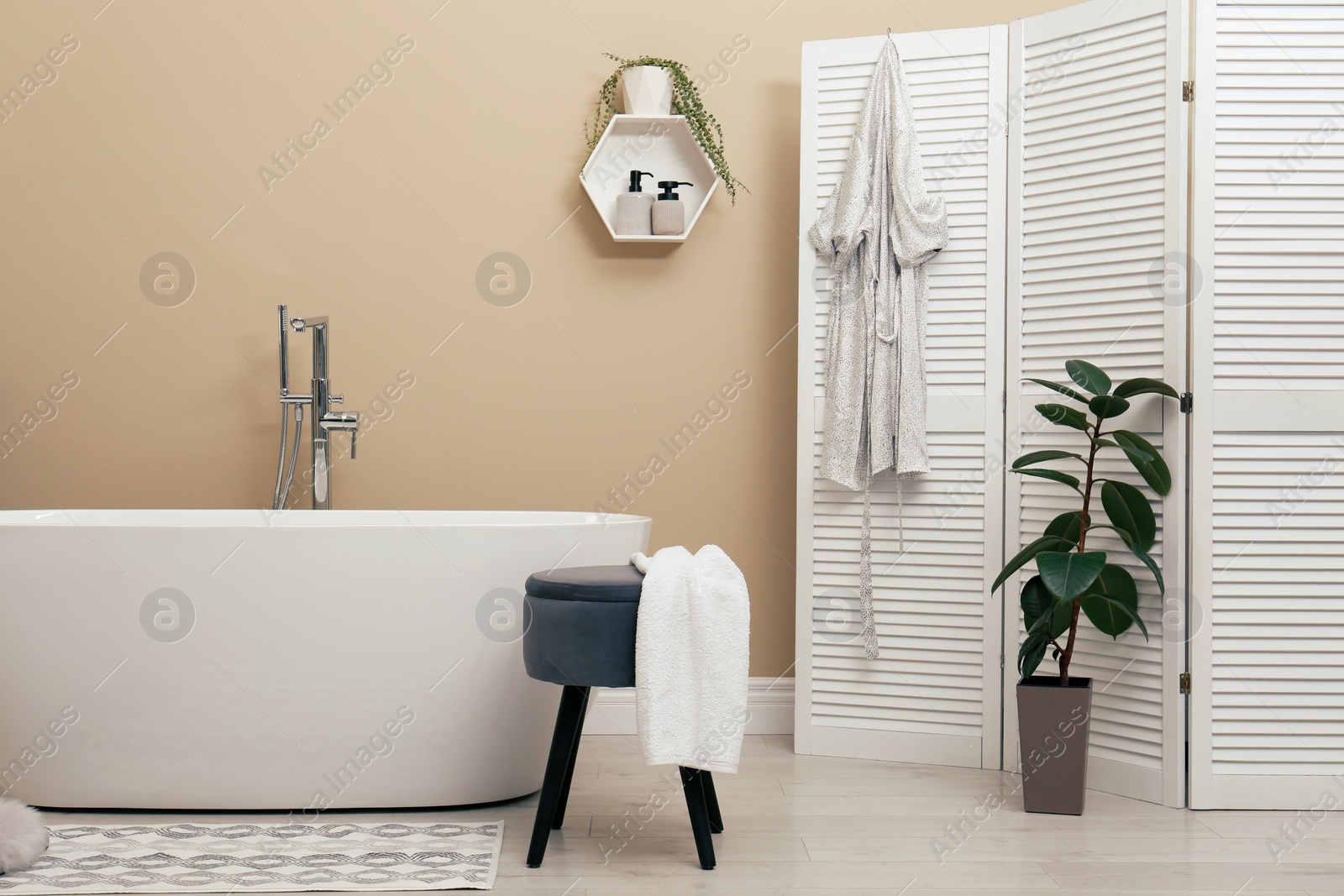 Photo of Cozy bathroom interior with stylish ceramic tub