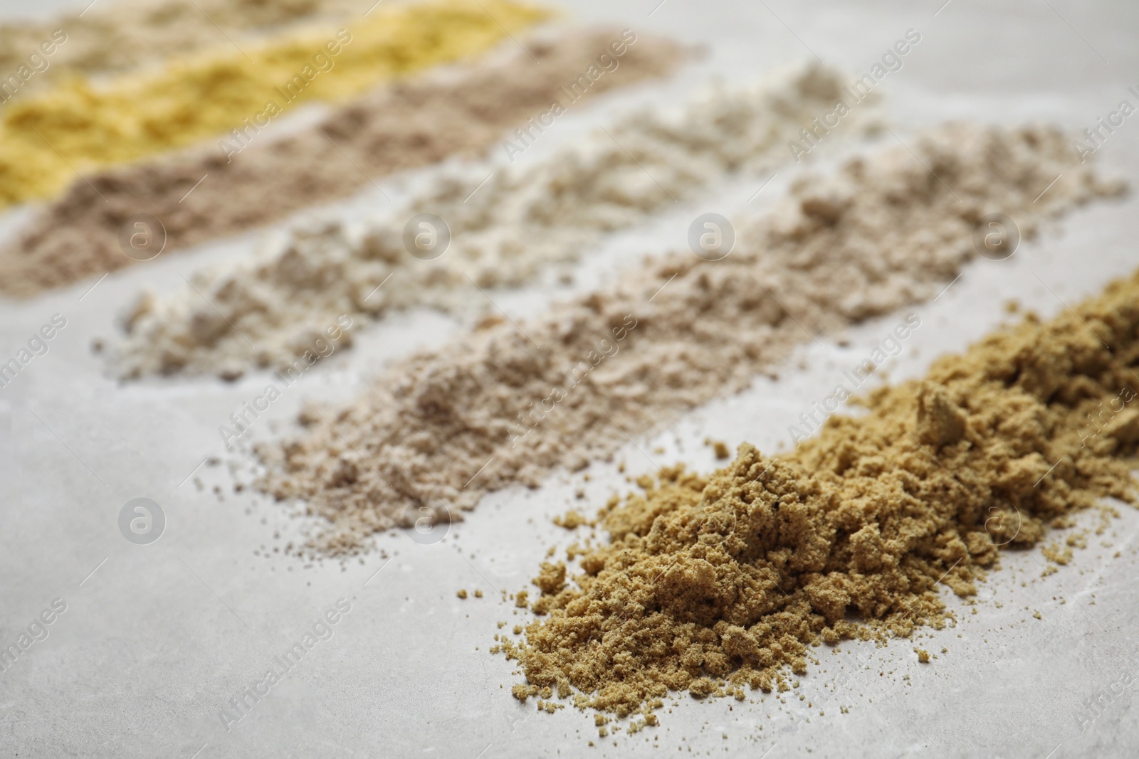 Photo of Composition with different types of flour on light background