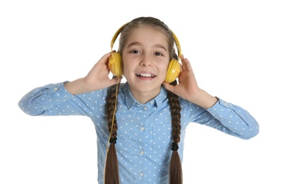 Photo of Cute little girl listening to music with headphones on white background
