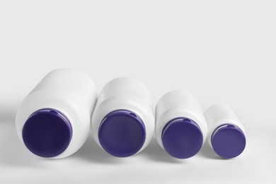 Photo of Closed plastic medicine bottles on white background. Medicament