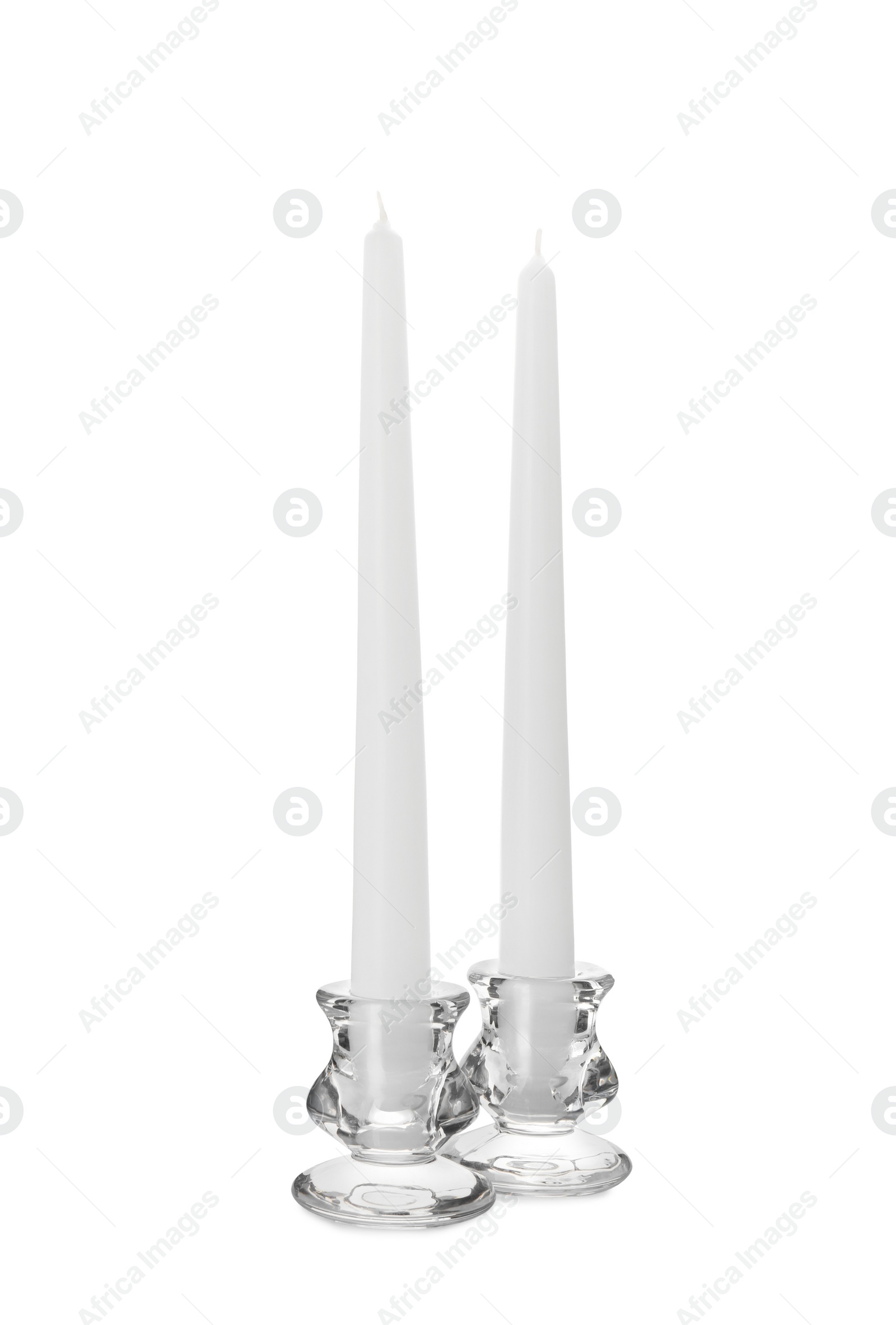 Photo of Elegant candlesticks with candles on white background