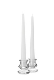Photo of Elegant candlesticks with candles on white background