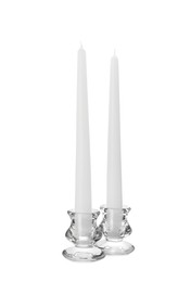 Elegant candlesticks with candles on white background