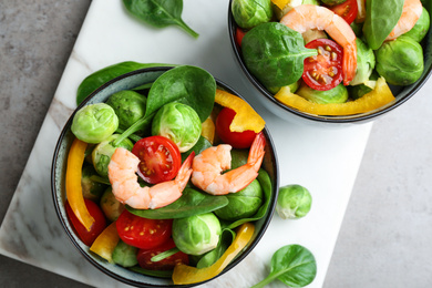 Photo of Tasty salad with Brussels sprouts on grey table, flat lay