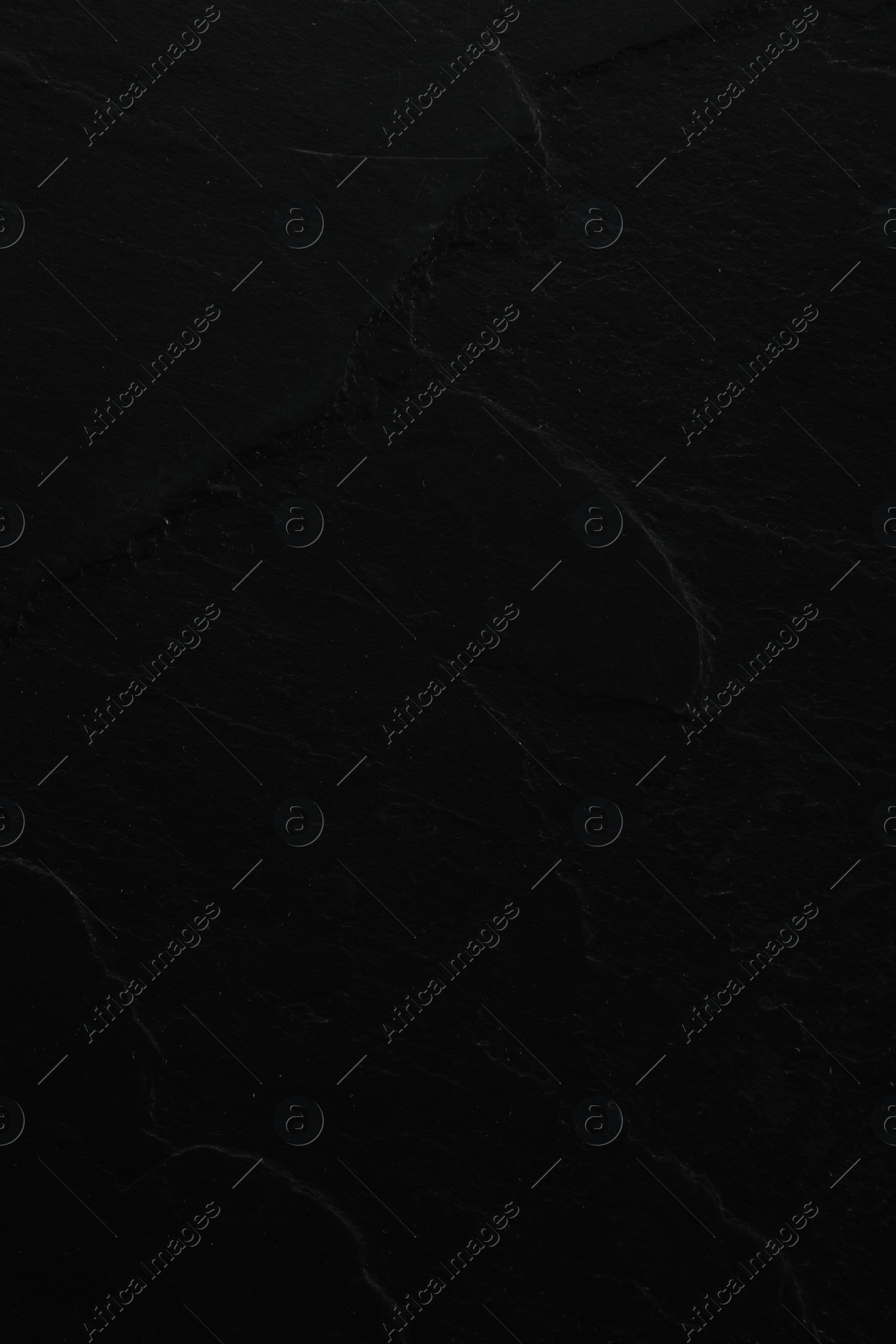 Photo of Texture of black stone surface as background, closeup