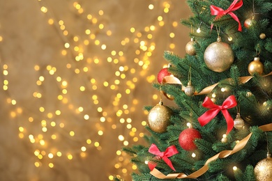 Beautiful Christmas tree with decor against blurred lights on background