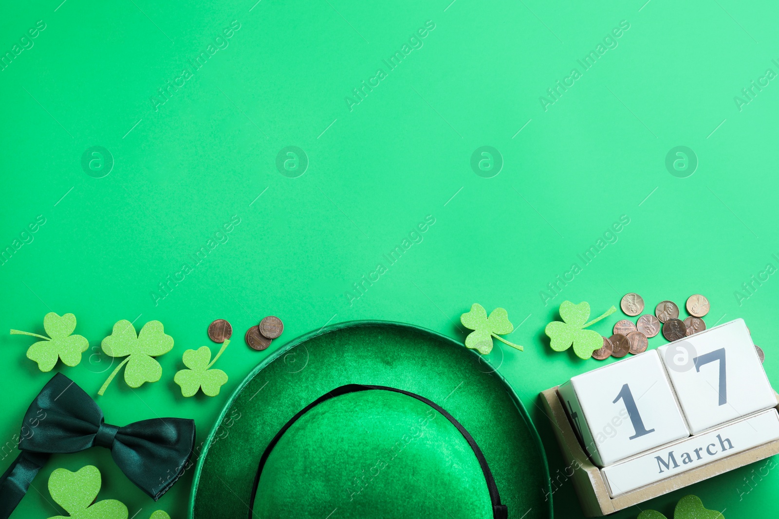 Photo of Flat lay composition with leprechaun hat on green background, space for text. St. Patrick's Day celebration
