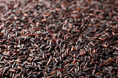 Raw brown rice as background, closeup view