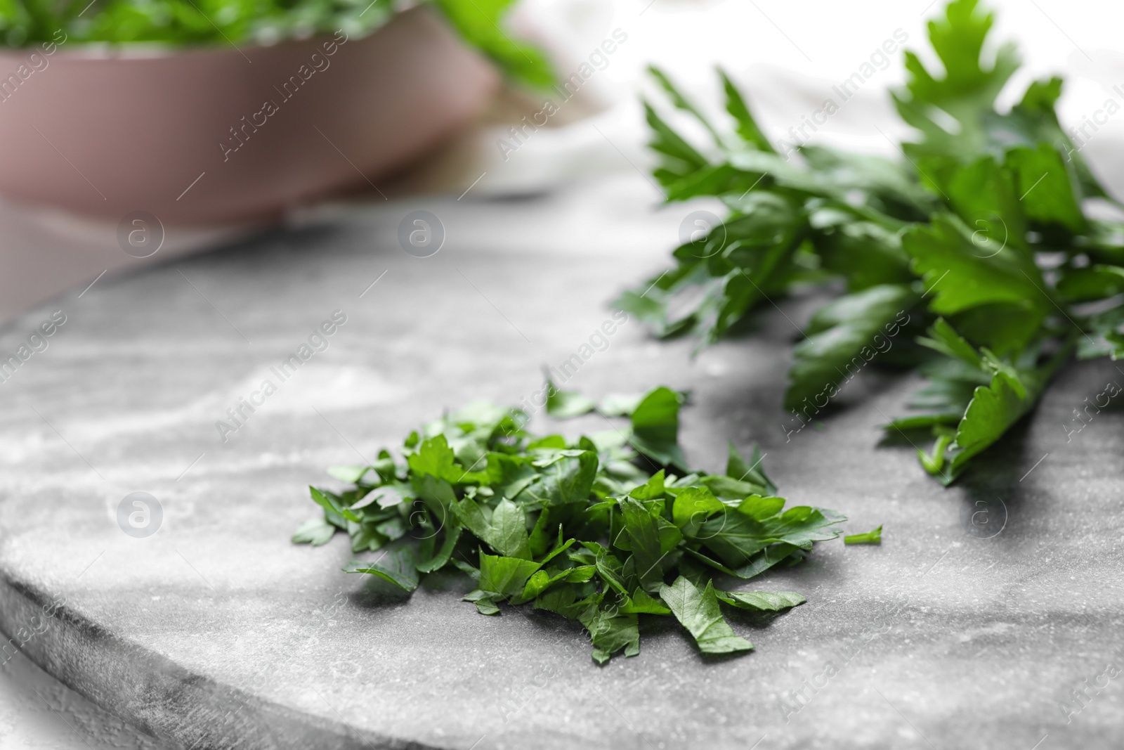 Photo of Fresh green parsley on marble board, closeup