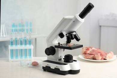 Slide with meat sample on microscope in laboratory. Poison detection