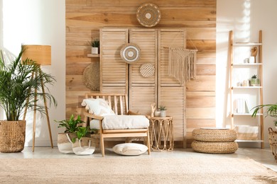 Photo of Stylish living room interior with comfortable wooden armchair and beautiful houseplants