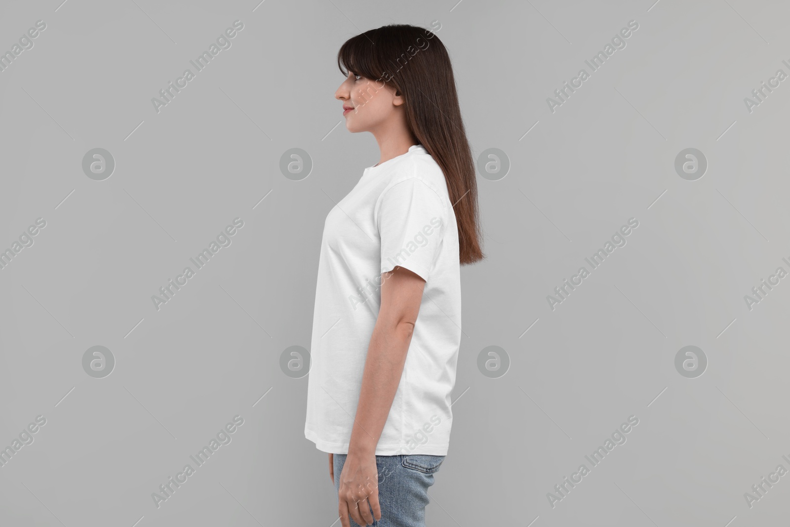 Photo of Woman in white t-shirt on grey background