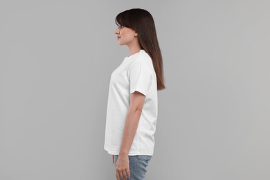 Photo of Woman in white t-shirt on grey background