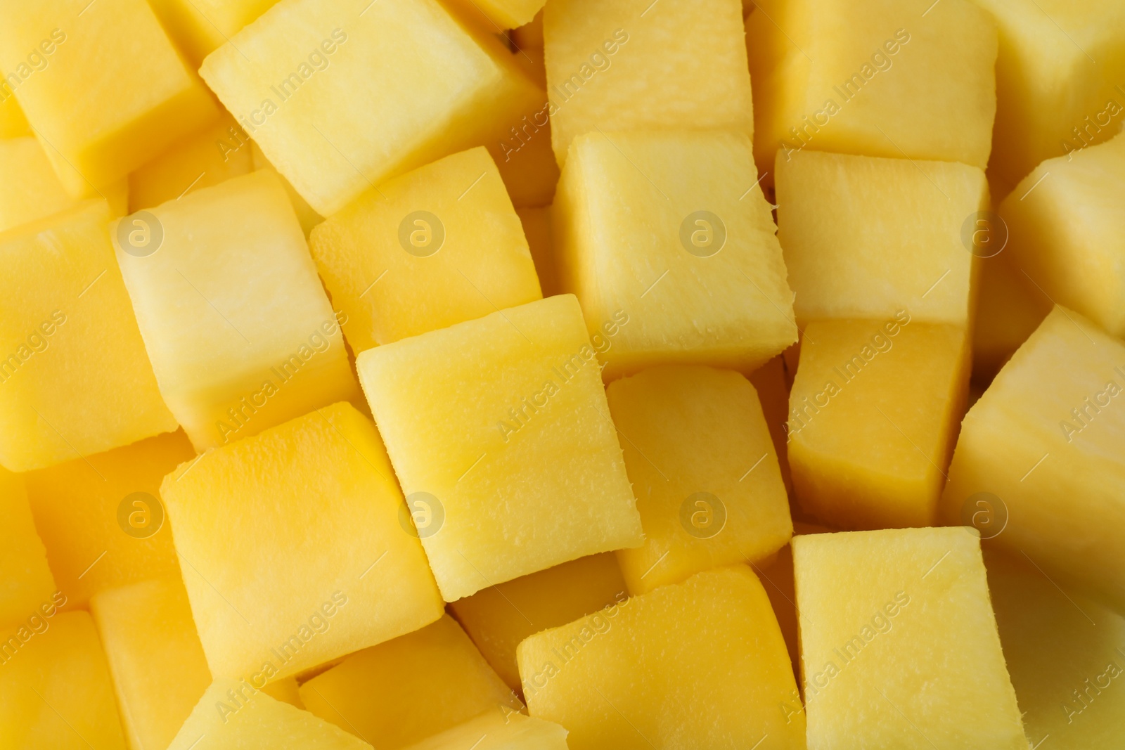 Photo of Many delicious mango cubes as background, closeup