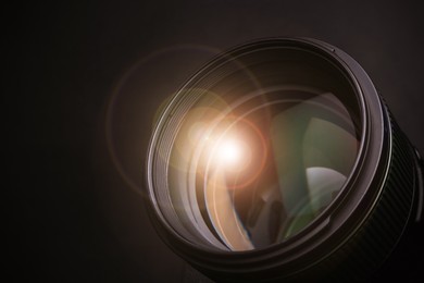 Image of Modern camera lens on black background, closeup