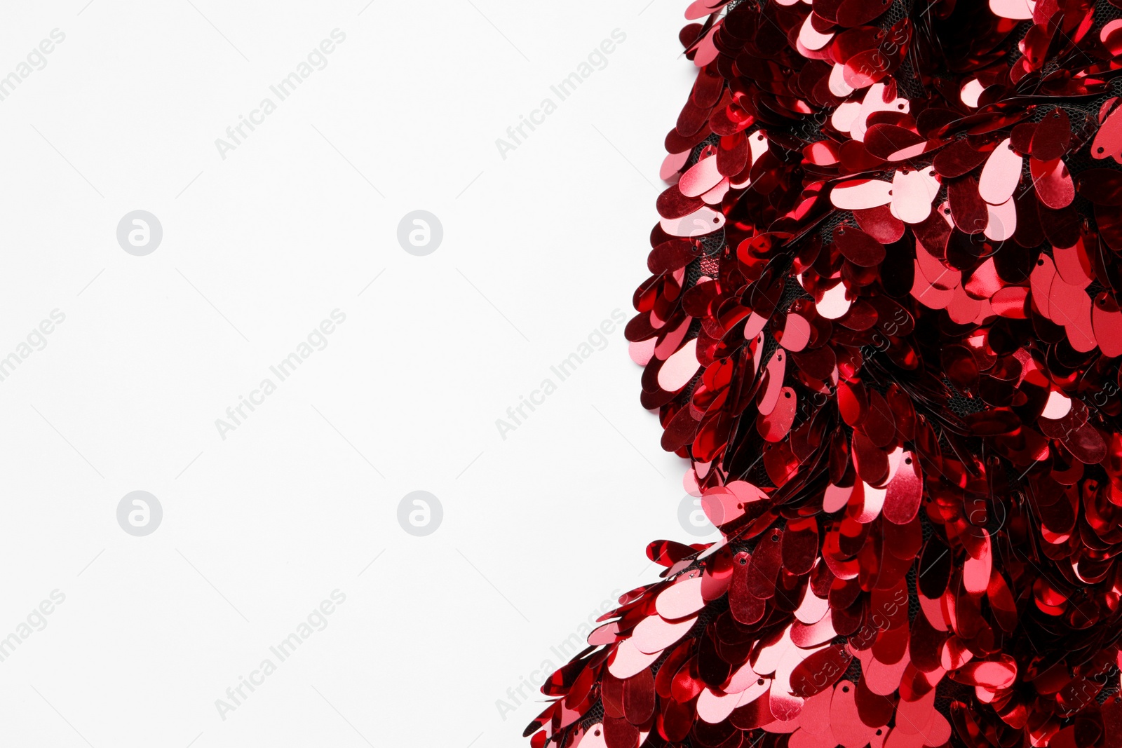 Photo of Beautiful red sequin fabric on white background, top view. Space for text