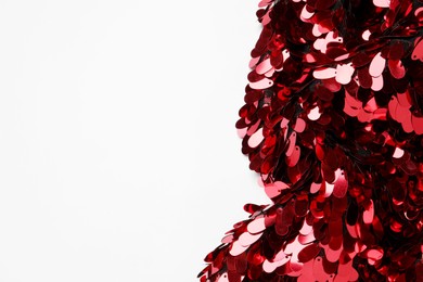 Photo of Beautiful red sequin fabric on white background, top view. Space for text