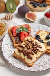 Different sweet delicious toasts on plate, closeup
