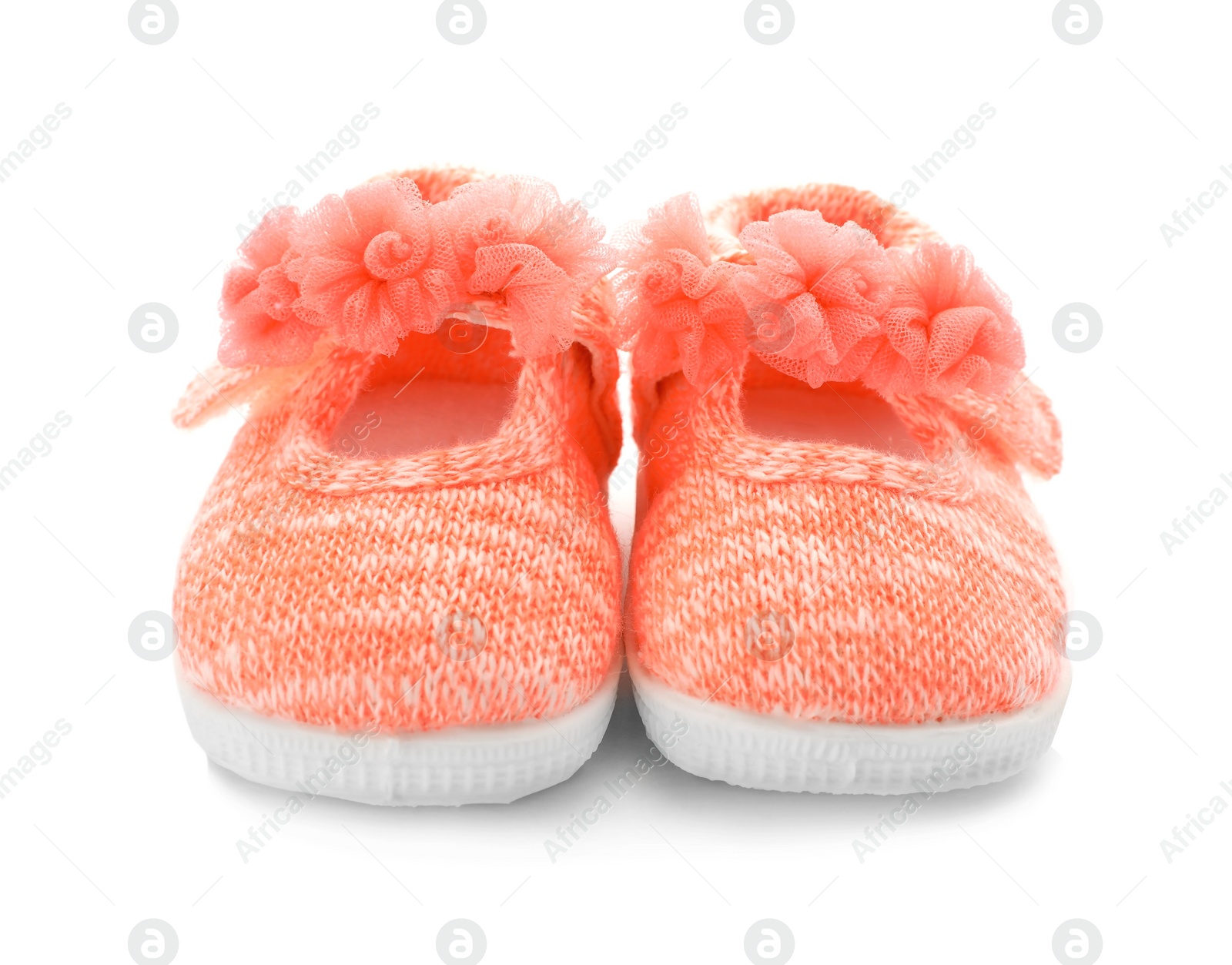 Photo of Pair of pink baby shoes on white background