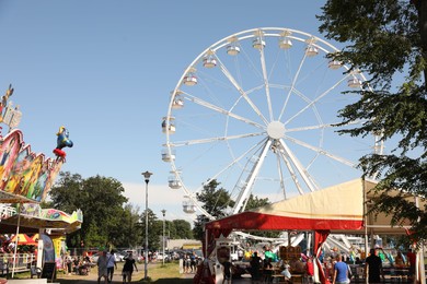 Photo of Darlowo, Poland - July 31 2022: Beautiful amusement park with ferris wheel on sunny day