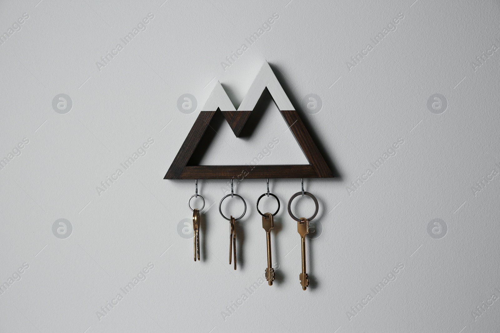 Photo of Wooden key holder on light grey wall