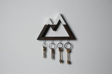 Photo of Wooden key holder on light grey wall