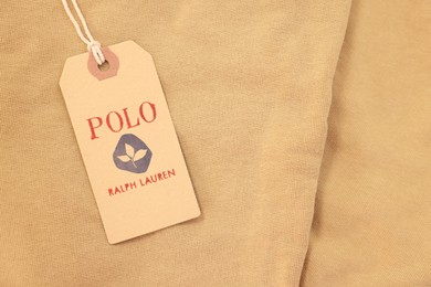 Photo of Leiden, Netherlands - December 6, 2023: Polo Ralph Lauren clothing tag on beige garment, top view