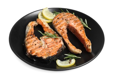 Photo of Plate with tasty salmon steaks, rosemary and lemon on white background