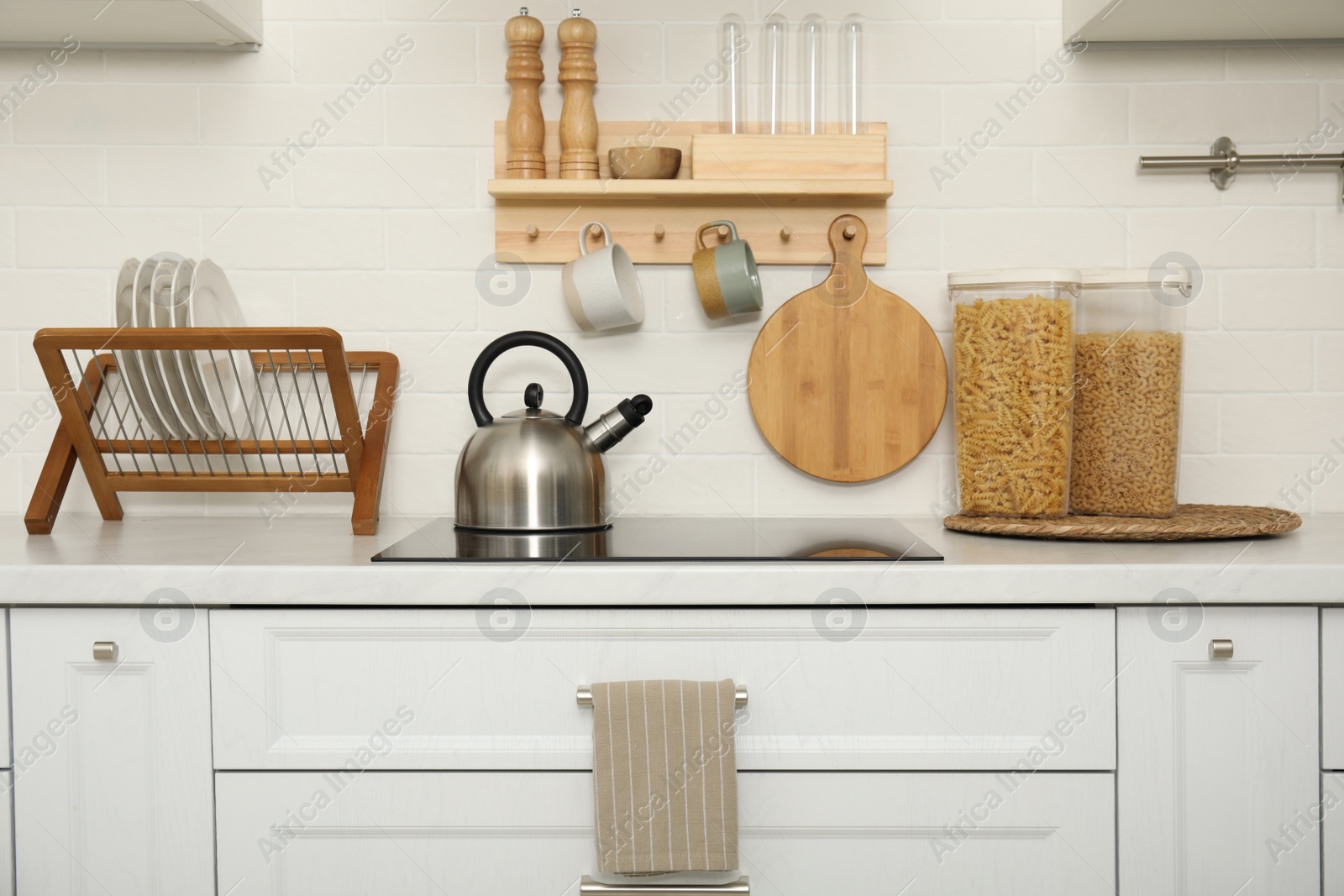 Photo of Clean towel hanging on drawer handle in kitchen