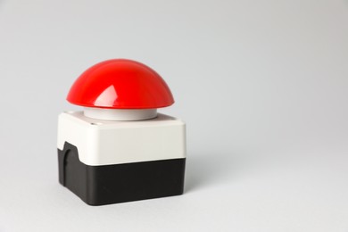 Photo of Red button of nuclear weapon on white background, closeup with space for text. War concept