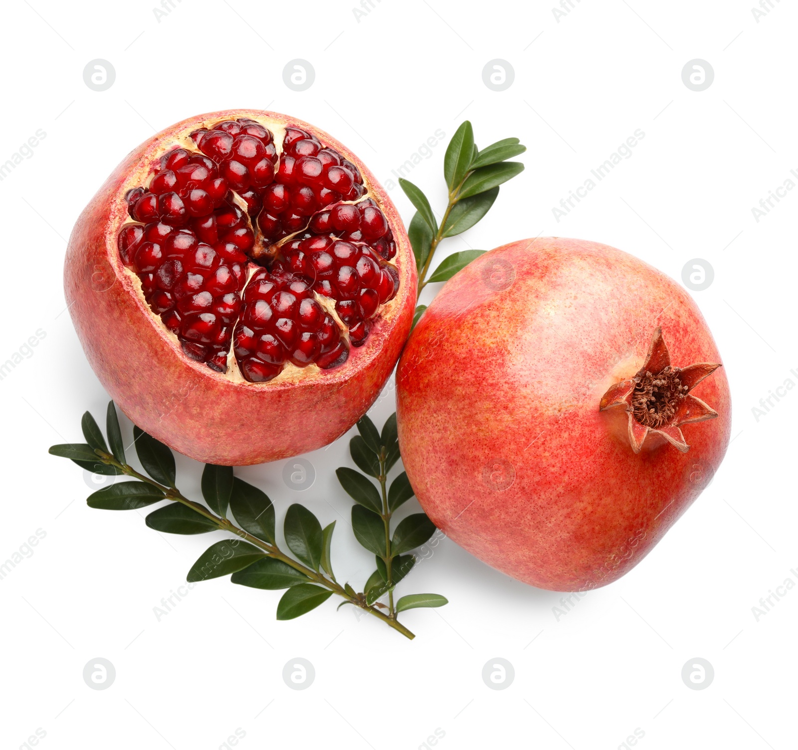 Photo of Whole and piece of fresh pomegranates with branches isolated on white, top view