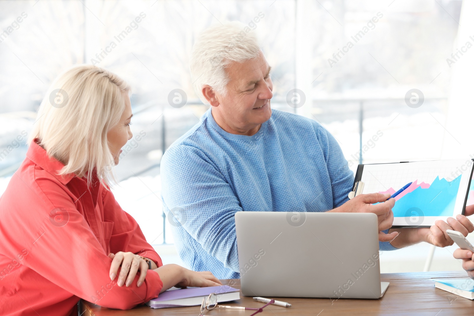 Photo of Group of people discussing ideas at table in office. Consulting service concept