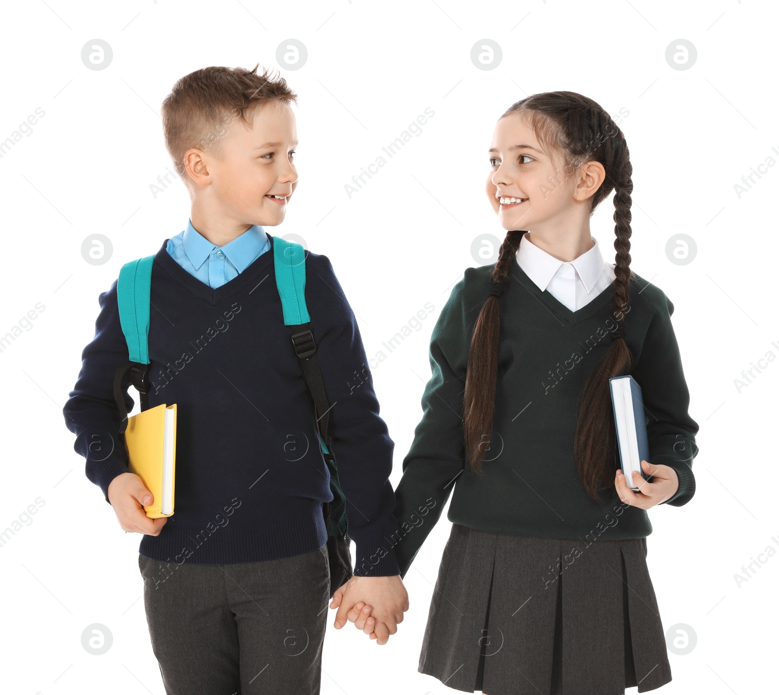 Photo of Portrait of cute children in school uniform on white background