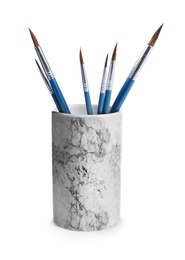 Photo of Holder with different paint brushes on white background
