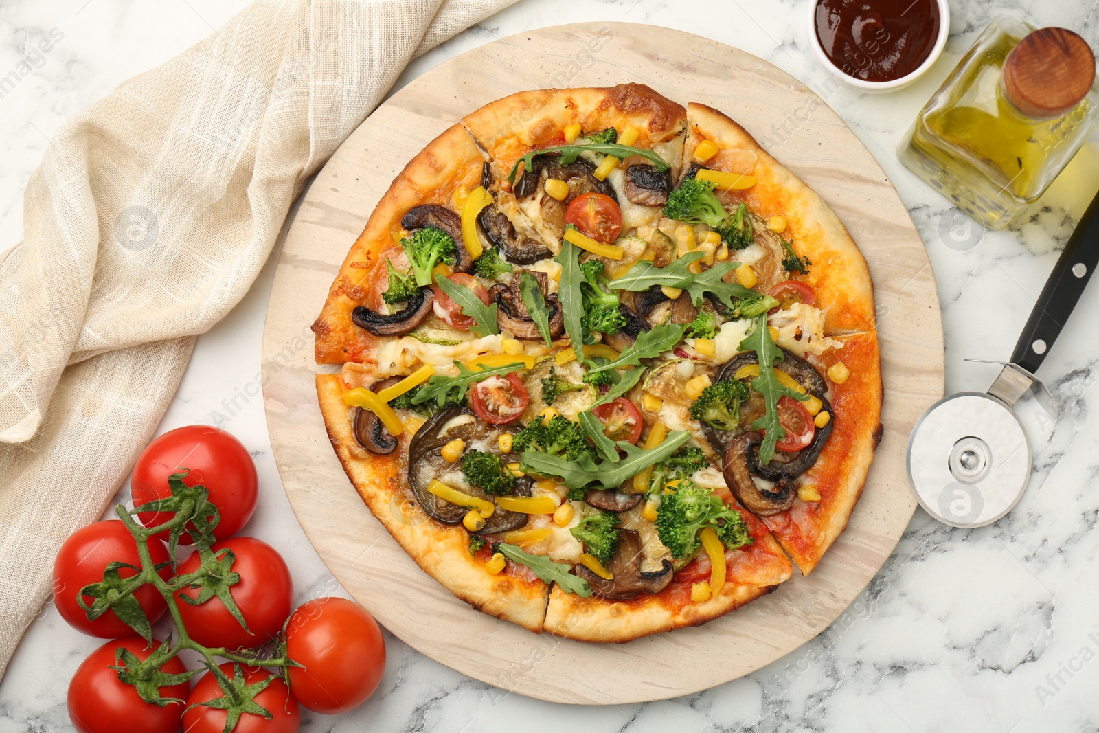 Photo of Delicious vegetarian pizza served on white marble table, flat lay