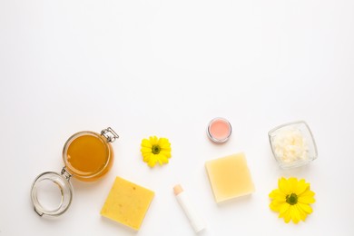 Photo of Flat lay composition with beeswax cosmetics on white background. Space for text