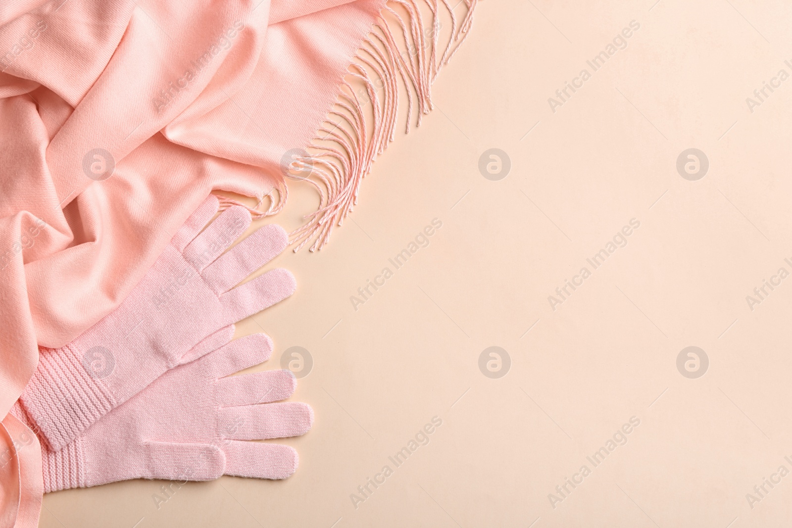 Photo of Flat lay composition with warm clothes on beige background. Space for text