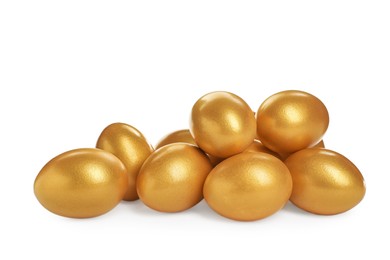 Photo of Many shiny golden eggs on white background