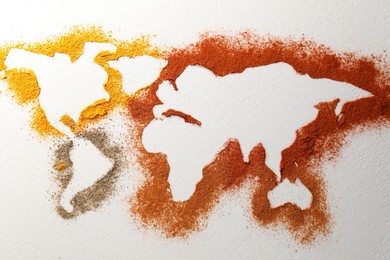 World map of different spices on white textured table, flat lay
