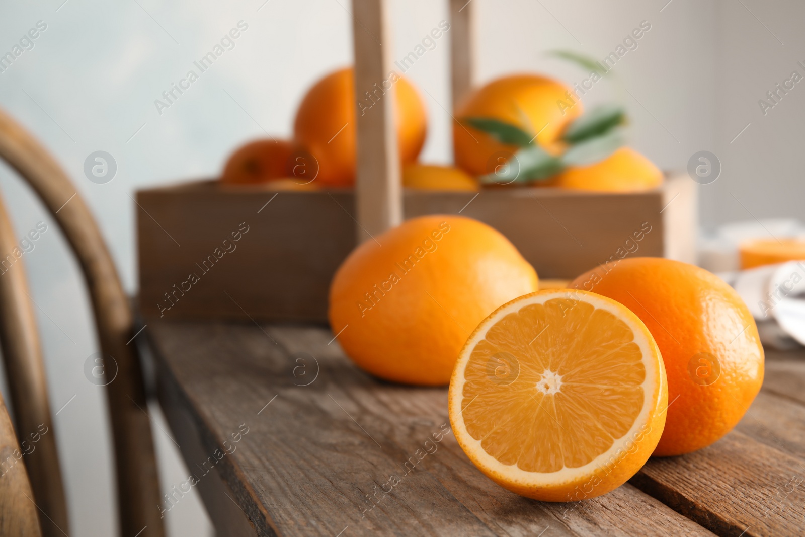 Photo of Fresh juicy oranges on wooden table. Space for text